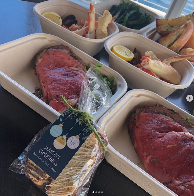 Prime rib and crab feast packed in to-go boxes