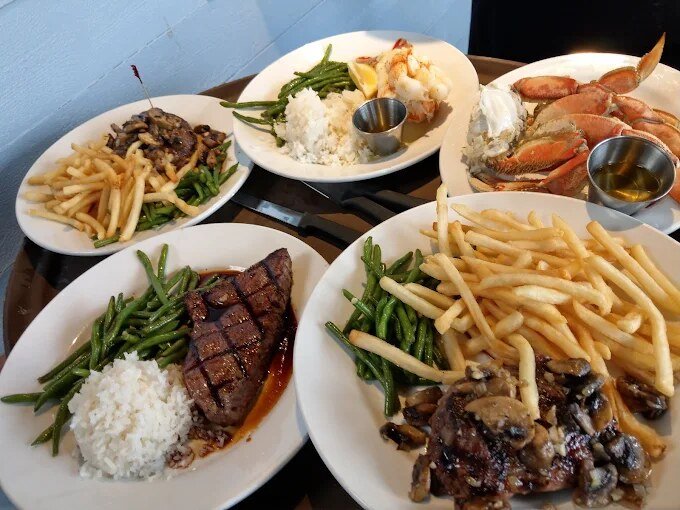 A spread of surf and turf — steaks, lobster and Dungeness crab — at The Crab House
