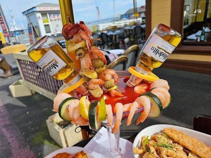 A shrimp michelada tower on the patio overlooking the marina
